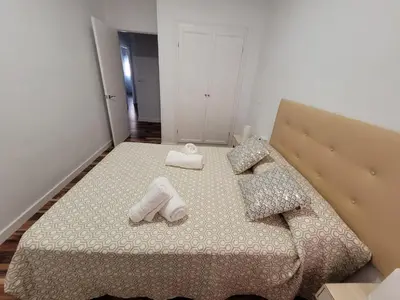 a bedroom with a bed with towels on it at La Playita Santa María Beach in Cádiz