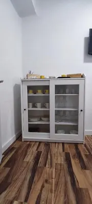 a white cabinet in a room with a wooden floor at La Playita Santa María Beach in Cádiz