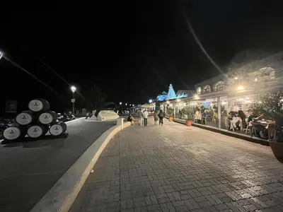 a street at night with people walking down the street at Mirador de Sanlucar 9 in Sanlúcar de Barrameda