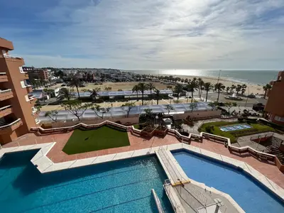 an aerial view of a resort with a swimming pool and the beach at Mirador de Sanlucar 9 in Sanlúcar de Barrameda