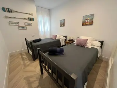 two beds in a small room with sidx sidx sidx sidx at Mirador de Sanlucar 9 in Sanlúcar de Barrameda