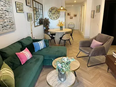 a living room with a green couch and a table at Mirador de Sanlucar 9 in Sanlúcar de Barrameda
