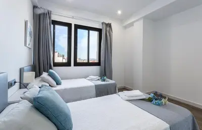 a bedroom with two beds and a window at New York Style Luxury 3 dormitorios in Jerez de la Frontera
