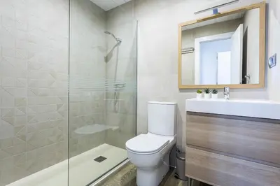 a bathroom with a toilet and a sink and a shower at New York Style Luxury 3 dormitorios in Jerez de la Frontera