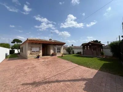 a small house with a brick driveway at VILLA ANDEMAR in Chiclana de la Frontera