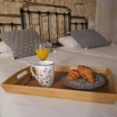 a tray with a cup and a plate of croissants and a glass at Jerez Palace House in Jerez de la Frontera