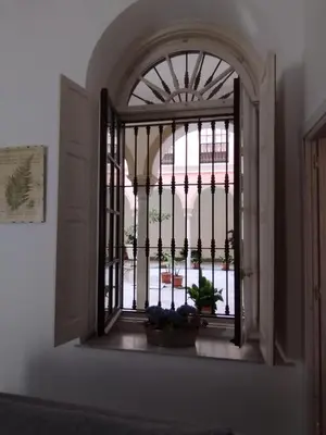 an open window with a view of a courtyard at Jerez Palace House in Jerez de la Frontera