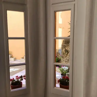 two windows with potted plants in a room at Jerez Palace House in Jerez de la Frontera