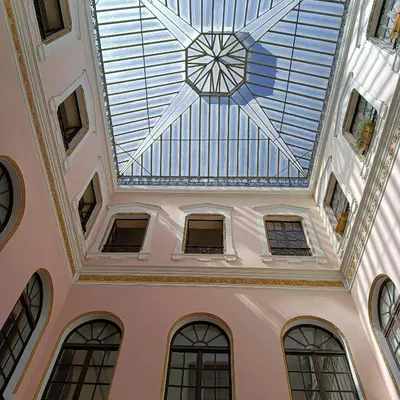 a ceiling in a building with windows at Jerez Palace House in Jerez de la Frontera