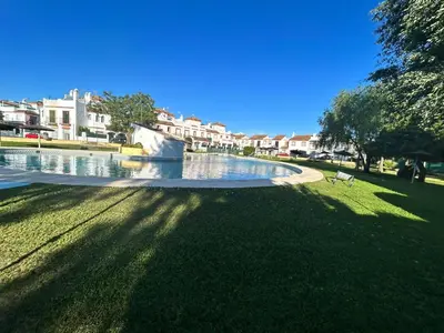 a park with a fountain in the grass at Apartamento Empul La Barrosa in Chiclana de la Frontera