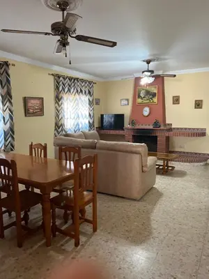 a living room with a couch and a table at VILLA LA MOMITA in Chiclana de la Frontera