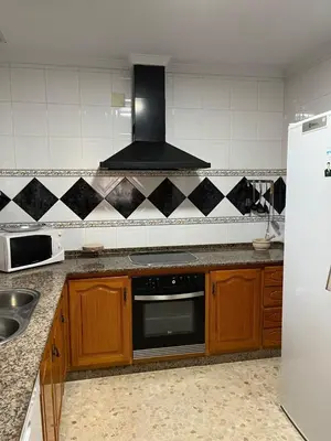 a kitchen with a sink and a stove top oven at VILLA LA MOMITA in Chiclana de la Frontera