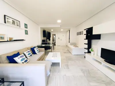 a living room with a couch and a tv at Loft Paseo Marítimo in Cádiz