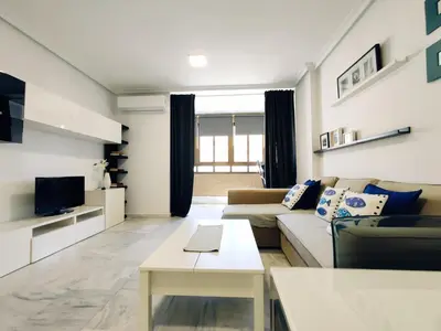 a living room with a couch and a table at Loft Paseo Marítimo in Cádiz