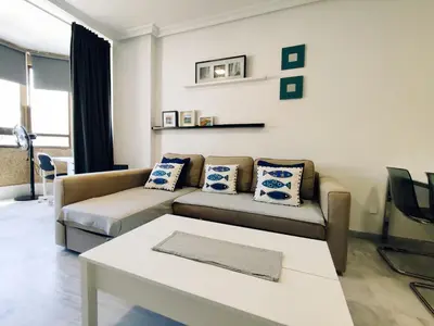 a living room with a couch and a table at Loft Paseo Marítimo in Cádiz