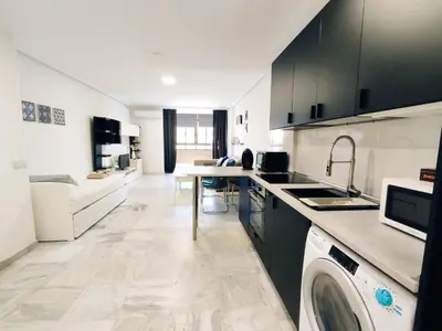 a kitchen with a washer and a washing machine in it at Loft Paseo Marítimo in Cádiz