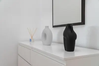 two vases sitting on a white dresser in a room at Apartoyou - Fuentebravía Playa in El Puerto de Santa María