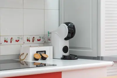a coffee maker on a counter in a kitchen at Apartoyou - Fuentebravía Playa in El Puerto de Santa María