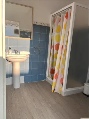a bathroom with a sink and a shower curtain at Fantástico chalet con piscina 2 km de la barrosa in Chiclana de la Frontera