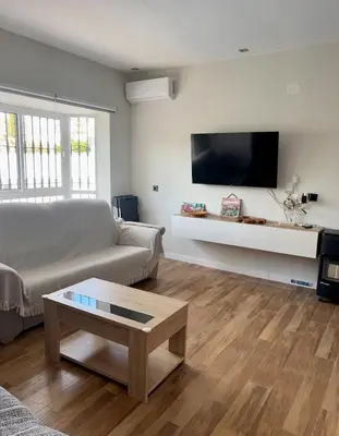 a living room with a couch and a coffee table at Fantástico chalet con piscina 2 km de la barrosa in Chiclana de la Frontera