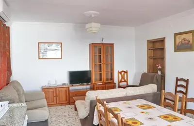 a living room with a couch and a table at Chalet Blue in Conil de la Frontera