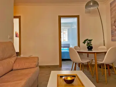 a living room with a couch and a table at Apartamento Alván - Ole Solutions in Jerez de la Frontera