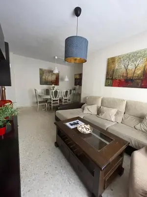 a living room with a couch and a table at Centro Sanlúcar Barrameda/Cuesta Ganado in Sanlúcar de Barrameda