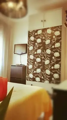 a bedroom with a wall with a flower pattern at Centro Sanlúcar Barrameda/Cuesta Ganado in Sanlúcar de Barrameda