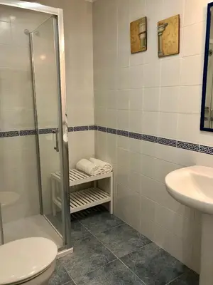 a bathroom with a shower and a toilet and a sink at Sol y playa Sanlúcar in Sanlúcar de Barrameda