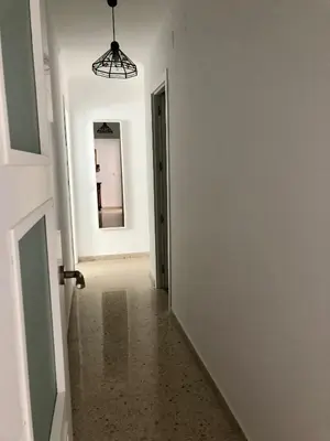 an empty hallway with a door and a mirror at Sol y playa Sanlúcar in Sanlúcar de Barrameda