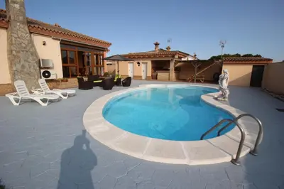 a swimming pool in the middle of a patio at LOS ALMENDROS in Chiclana de la Frontera