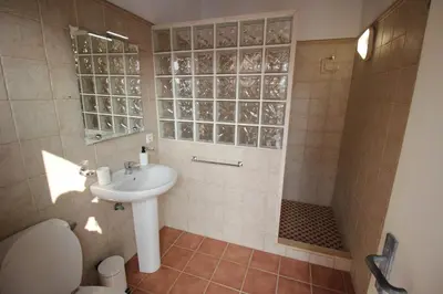 a bathroom with a sink and a toilet and a shower at LOS ALMENDROS in Chiclana de la Frontera