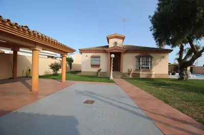 a house with a walkway in front of it at LOS ALMENDROS in Chiclana de la Frontera