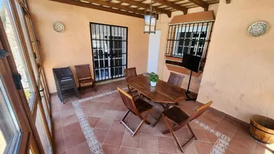 a balcony with a table and chairs in a room at LOS ALMENDROS in Chiclana de la Frontera