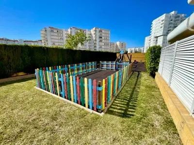 a colorful fence in the grass in a city at GATU PREMIUM Villa Poniente, junto la playa de Valdelagrana 