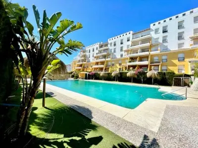 a swimming pool in front of a apartment building at GATU PREMIUM Villa Poniente, junto la playa de Valdelagrana 