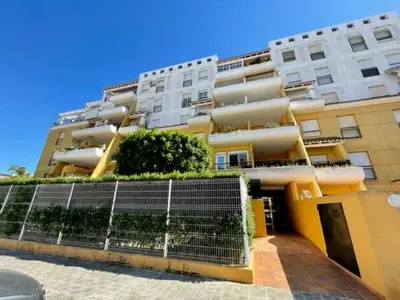 a large apartment building with plants in front of it at GATU PREMIUM Villa Poniente, junto la playa de Valdelagrana 