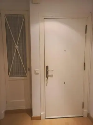 a white door with a window in a room at Cantabrico playa Grupo AC Gestion in Cádiz