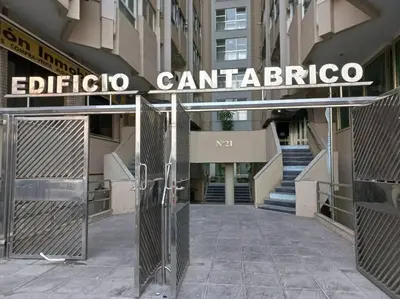 a gate in front of a building with a sign at Cantabrico playa Grupo AC Gestion in Cádiz