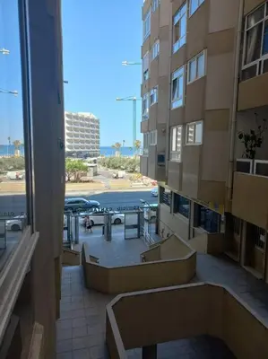 a view of a balcony of a building with a table at Cantabrico playa Grupo AC Gestion in Cádiz