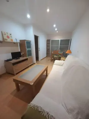a bedroom with a bed and a table and a desk at Cantabrico playa Grupo AC Gestion in Cádiz