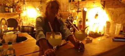 a woman sitting at a bar with two glasses of milk at Azafran Jerez estudio in Jerez de la Frontera
