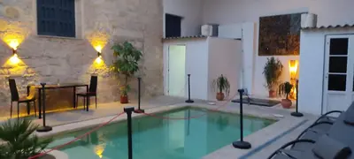 a swimming pool in the middle of a building at Azafran Jerez estudio in Jerez de la Frontera