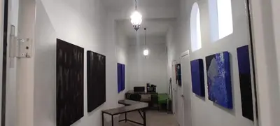 a hallway with many paintings on the walls at Azafran Jerez estudio in Jerez de la Frontera