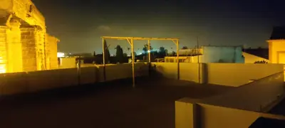 a view of the rooftop of a building at night at Azafran Jerez estudio in Jerez de la Frontera