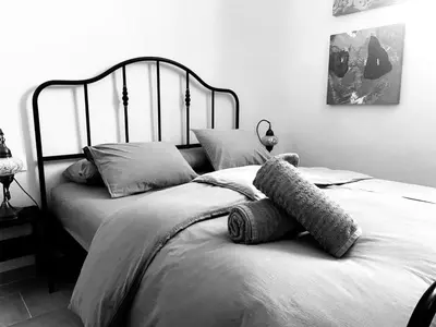 a black and white photo of a bedroom with a bed at Azafran Jerez estudio in Jerez de la Frontera