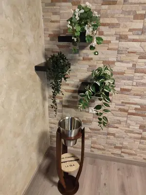 a corner of a room with plants on a brick wall at Playas, cultura y gastronomía en Casa Sarco 2 habitaciones in San Fernando