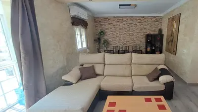 a living room with a large white couch in a room at Playas, cultura y gastronomía en Casa Sarco 2 habitaciones in San Fernando