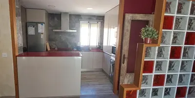 a kitchen with a counter and a refrigerator in a room at Playas, cultura y gastronomía en Casa Sarco 2 habitaciones in San Fernando