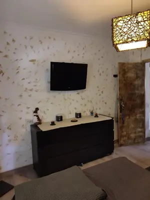 a living room with a tv on a wall at Playas, cultura y gastronomía en Casa Sarco 2 habitaciones in San Fernando